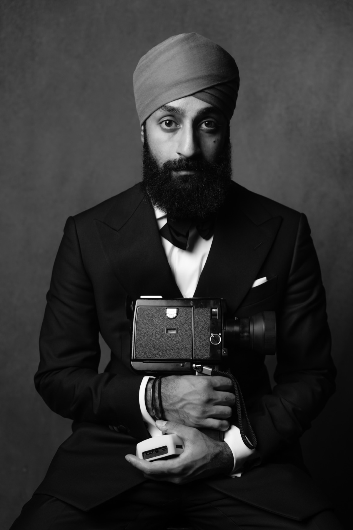 Portrait of Sanvir Chana with a cine camera